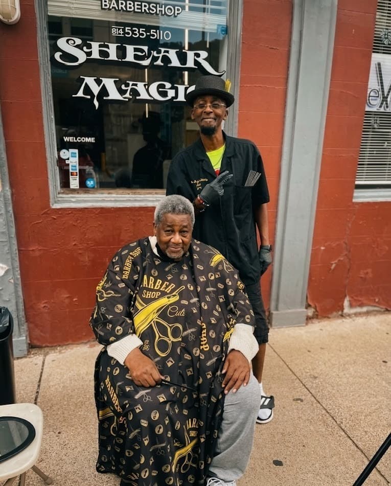 Shear Magic Barbershop storefront with barber and client